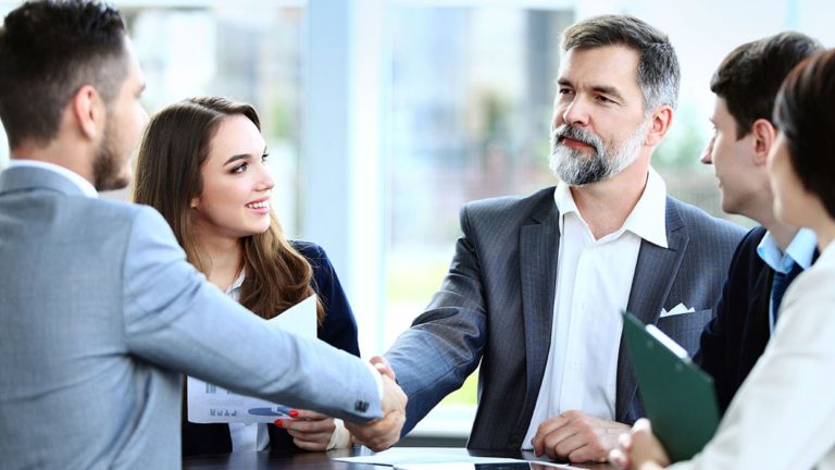 A businessman shaking hands with clients and busy in building customer interactions for a business